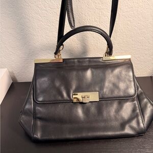 Michael Kors Black and Gold Satchel .